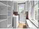 Well-lit laundry room with built-in cabinets, a washer, and a window at 920 Queens Rd, Charlotte, NC 28207