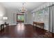 Spacious living room with hardwood floors, large windows and chandelier at 920 Queens Rd, Charlotte, NC 28207