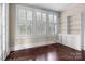 Bright room with hardwood floors, built-in shelving, and large windows at 920 Queens Rd, Charlotte, NC 28207