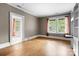 Empty room with hardwood floors, white trim, and large windows at 920 Queens Rd, Charlotte, NC 28207