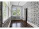 Cozy sunroom with lots of light, pretty wallpaper and tile floors at 920 Queens Rd, Charlotte, NC 28207