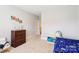 A bright bedroom shows a bed, dresser, and toys, offering a warm and playful space at 1004 Princesa Dr, Matthews, NC 28104