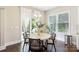 Bright dining room featuring a round table, elegant chairs, and access to an outdoor deck at 1004 Princesa Dr, Matthews, NC 28104