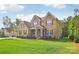 Attractive two-story brick home with manicured lawn and professional landscaping at 1004 Princesa Dr, Matthews, NC 28104