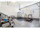 Functional garage space featuring ample storage, an exercise area with a treadmill, and an overhead door at 1004 Princesa Dr, Matthews, NC 28104