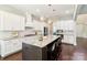 Bright kitchen featuring a large island with seating and modern pendant lighting at 1004 Princesa Dr, Matthews, NC 28104