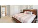 Cozy main bedroom showcasing a wood bed frame, neutral color scheme, and soft carpet at 1004 Princesa Dr, Matthews, NC 28104