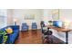 Cozy home office with hardwood floors, blue couch and a modern desk setup at 1004 Princesa Dr, Matthews, NC 28104