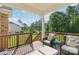 Covered porch with wicker chairs, an ottoman, and views of a lush green backyard at 1004 Princesa Dr, Matthews, NC 28104