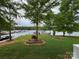 Serene backyard view overlooking the lake and docks with lush greenery at 101 Dogwood Cir, New London, NC 28127