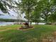Lush green backyard with manicured landscaping and peaceful lake view at 101 Dogwood Cir, New London, NC 28127