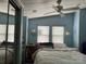 Cozy bedroom with blue walls, bright natural light, and ample closet space at 101 Dogwood Cir, New London, NC 28127