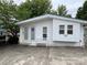 Charming white home with a cozy bench, vinyl siding, and well-maintained landscaping at 101 Dogwood Cir, New London, NC 28127