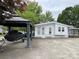 Exterior showcasing covered jet ski parking near the entrance of the lake home at 101 Dogwood Cir, New London, NC 28127