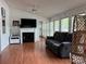 Cozy living room with a fireplace, mantle, and comfy gray couch for relaxing at 101 Dogwood Cir, New London, NC 28127