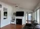 Bright living room with fireplace, flat screen tv, and comfortable sofa at 101 Dogwood Cir, New London, NC 28127