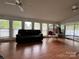 Spacious living room with hardwood floors, comfortable seating, and ample natural light at 101 Dogwood Cir, New London, NC 28127