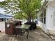 Outdoor patio featuring a brick grill, dining table, and covered grill, perfect for entertaining at 101 Dogwood Cir, New London, NC 28127