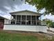 Rear view of house, showcasing a screened-in porch, perfect for outdoor relaxation at 101 Dogwood Cir, New London, NC 28127