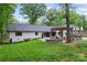 Beautiful backyard with a patio, pergola, and lush green lawn perfect for outdoor entertaining and relaxation at 1118 Crestbrook Dr, Charlotte, NC 28211