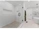 Elegant bathroom featuring a glass-enclosed shower with white tile, a freestanding tub, and modern finishes at 1118 Crestbrook Dr, Charlotte, NC 28211