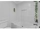 Beautiful bathroom featuring white subway tile, a soaking tub with glass enclosure, and decorative greenery at 1118 Crestbrook Dr, Charlotte, NC 28211