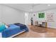 Bright bedroom with a cozy bed, desk area, hardwood floors, and natural light streaming through the window at 1118 Crestbrook Dr, Charlotte, NC 28211