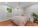 Bedroom featuring hardwood floors, large window, a plant, and a queen size bed with white headboard at 1118 Crestbrook Dr, Charlotte, NC 28211