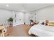 Bright bedroom with hardwood floors, neutral walls, double door closet, a ceiling fan, and a desk at 1118 Crestbrook Dr, Charlotte, NC 28211