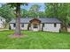 Charming single story home with a freshly manicured lawn and mature tree creates lovely curb appeal at 1118 Crestbrook Dr, Charlotte, NC 28211