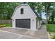 Exterior view of a modern two-car garage with white brick facade and black door at 1118 Crestbrook Dr, Charlotte, NC 28211