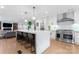 Open-concept kitchen with a large island, stainless steel appliances, pendant lighting, and access to living spaces at 1118 Crestbrook Dr, Charlotte, NC 28211