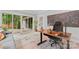 Bright home office with sliding glass doors, a modern desk, an ergonomic chair, and a colorful painting at 1118 Crestbrook Dr, Charlotte, NC 28211