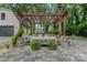 An outdoor living area featuring a stone patio, comfortable seating, and a pergola for shade and relaxation at 1118 Crestbrook Dr, Charlotte, NC 28211