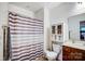 Bathroom featuring a shower with a curtain, toilet, vanity with sink, and a cabinet for storage at 1150 Hearth Sw Ln, Concord, NC 28025
