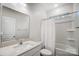 Clean bathroom with a large mirror, white cabinetry and tub shower with white curtain at 1150 Hearth Sw Ln, Concord, NC 28025