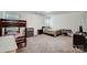 Spacious bedroom featuring a bunk bed, queen bed, and a modern dresser with ample natural light from the windows at 1150 Hearth Sw Ln, Concord, NC 28025