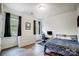 Comfortable bedroom with desk, dresser, and two bright windows with black curtains at 1150 Hearth Sw Ln, Concord, NC 28025