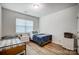 Bright bedroom with two twin beds, wood floors and a window letting in natural light at 1150 Hearth Sw Ln, Concord, NC 28025
