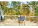 Outdoor deck with a dining table and chairs, perfect for enjoying the surrounding nature views at 1150 Hearth Sw Ln, Concord, NC 28025