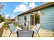 Enjoy outdoor dining on this lovely deck with a table, chairs, and sliding glass door to the home at 1150 Hearth Sw Ln, Concord, NC 28025