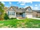 Charming home with stone accents, blue shutters, manicured lawn, and an attached two-car garage at 1150 Hearth Sw Ln, Concord, NC 28025