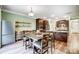 Spacious kitchen and dining area with stainless steel appliances, granite countertops and a large dining table at 1150 Hearth Sw Ln, Concord, NC 28025