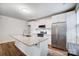 Modern kitchen with stainless steel appliances, white cabinets, granite countertops, and a kitchen island with a sink at 1150 Hearth Sw Ln, Concord, NC 28025
