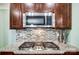 Modern kitchen featuring granite countertops, stainless steel appliances, and a stylish mosaic tile backsplash at 1150 Hearth Sw Ln, Concord, NC 28025