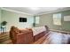 Cozy living room with neutral paint, hardwood floors, and a large comfortable couch at 1150 Hearth Sw Ln, Concord, NC 28025
