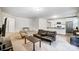 Open-concept living room with modern finishes and seamless flow to a bright kitchen area with stainless steel appliances at 1150 Hearth Sw Ln, Concord, NC 28025