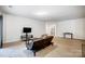 Spacious living room with carpeted floors and featuring a door to the bathroom at 1150 Hearth Sw Ln, Concord, NC 28025