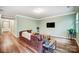 Bright and airy living room with hardwood floors, modern lighting, and a neutral color scheme at 1150 Hearth Sw Ln, Concord, NC 28025