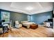 Bright main bedroom boasts great natural light, tray ceiling, wood-look floors, and a stylish sitting area at 1150 Hearth Sw Ln, Concord, NC 28025